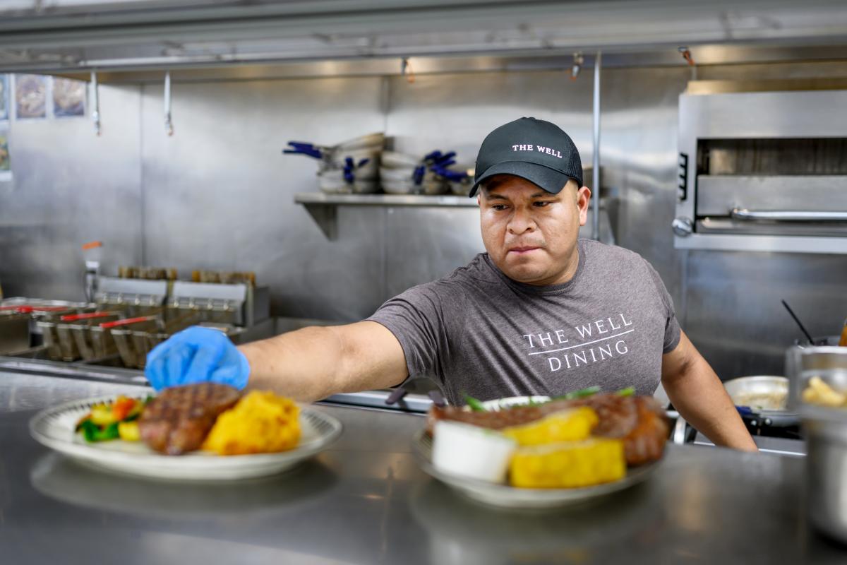 The Well cook serving food